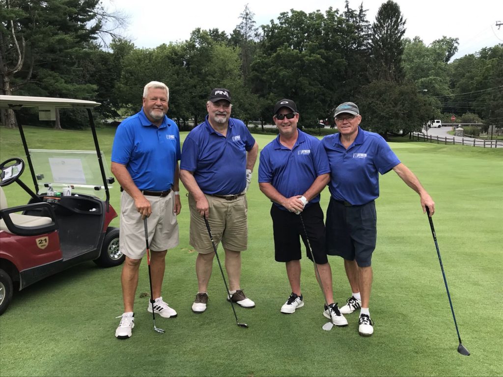 Four men smiling at the Mennonite Home Communities Annual Golf Outing